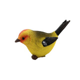 Colorful bird figurine with yellow body, red head, and black wings on a white background