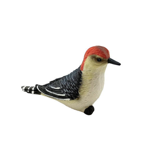 Figurine of a red-headed woodpecker on a white background