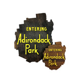 2 wooden signs shaped like the Adirondack Park with 'Entering Adirondack Park' text on a white background